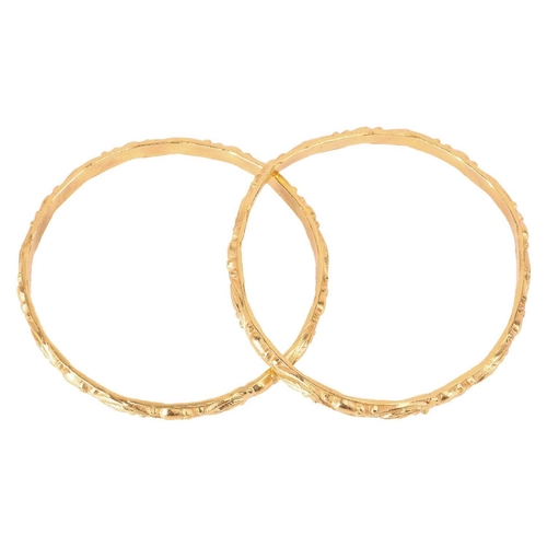 114 - A pair of closed bangles of foliate design, in unmarked yellow metal testing as high carat, inner di... 