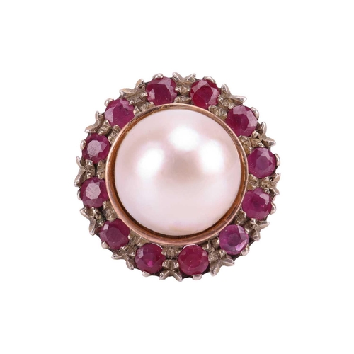 120 - A Mabé pearl and ruby cocktail ring, centred with a round Mabé pearl of 12.7 mm in diameter, encircl... 