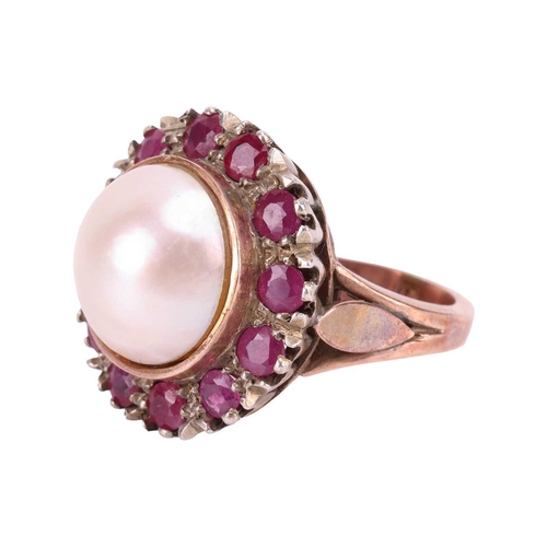 120 - A Mabé pearl and ruby cocktail ring, centred with a round Mabé pearl of 12.7 mm in diameter, encircl... 