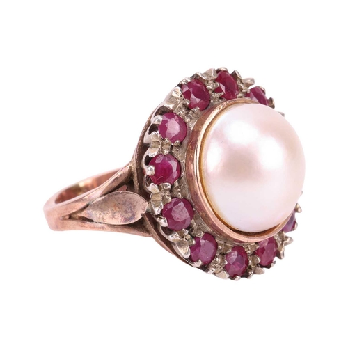 120 - A Mabé pearl and ruby cocktail ring, centred with a round Mabé pearl of 12.7 mm in diameter, encircl... 