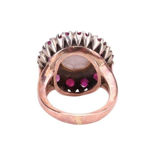 120 - A Mabé pearl and ruby cocktail ring, centred with a round Mabé pearl of 12.7 mm in diameter, encircl... 