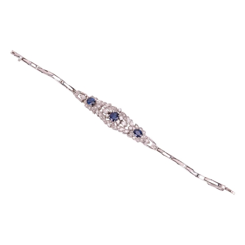 124 - A sapphire and diamond bracelet, centred with a foliate five-section panel embellished with three ci... 