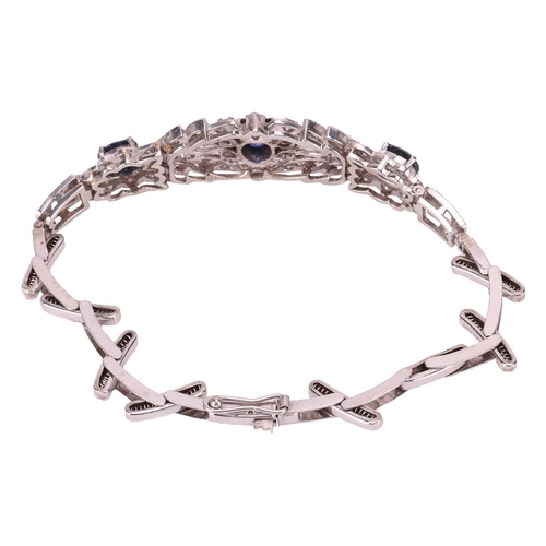 124 - A sapphire and diamond bracelet, centred with a foliate five-section panel embellished with three ci... 