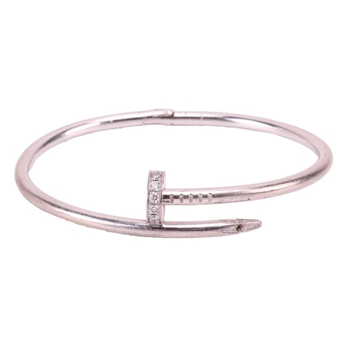 126 - Cartier - a 'Juste un Clou' diamond-set bracelet in 18ct white gold, classic model, of a hinged bent... 