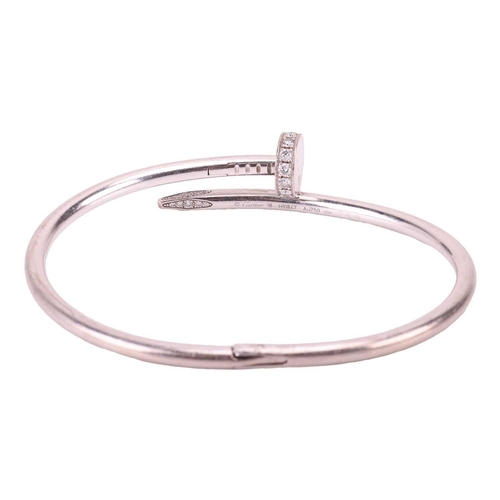 126 - Cartier - a 'Juste un Clou' diamond-set bracelet in 18ct white gold, classic model, of a hinged bent... 