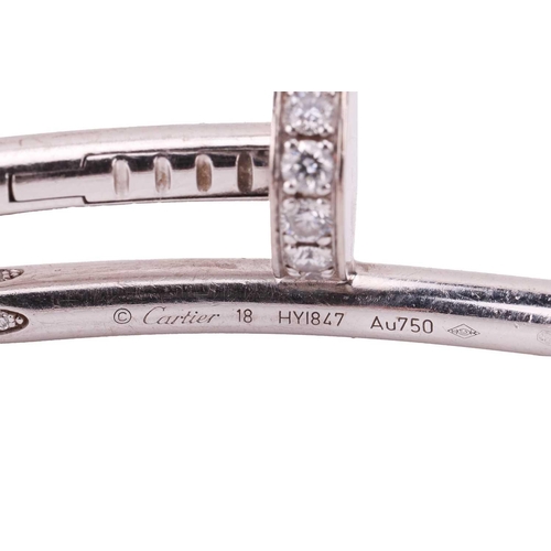 126 - Cartier - a 'Juste un Clou' diamond-set bracelet in 18ct white gold, classic model, of a hinged bent... 