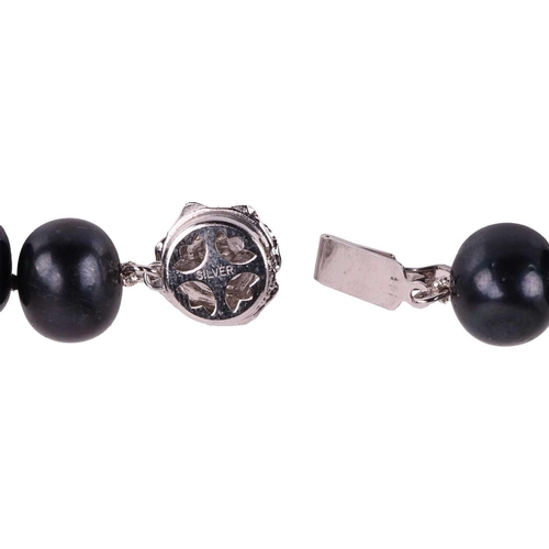 17 - A cultured black pearl necklace, comprising a row of off-round black pearls, measuring 12.3 mm, comp... 