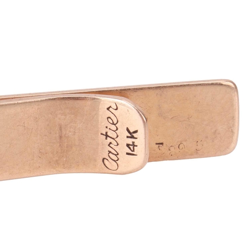 19 - Cartier - a tie clip, in form of a plain polished bar, yellow metal signed and marked '14K', serial ... 