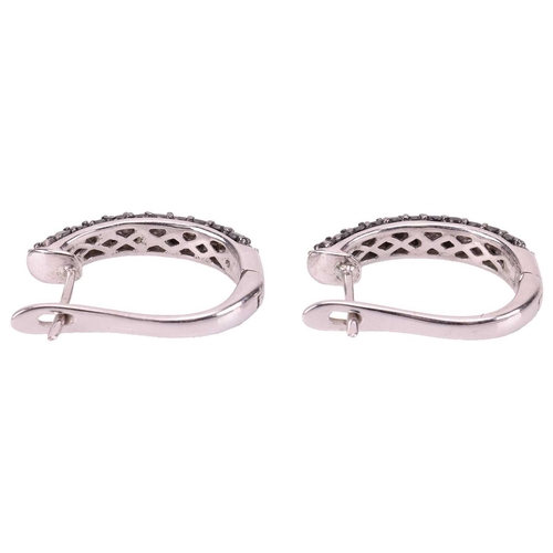 30 - A pair of diamond-set hoop earrings, each set with alternating rows of black and white circular-cut ... 