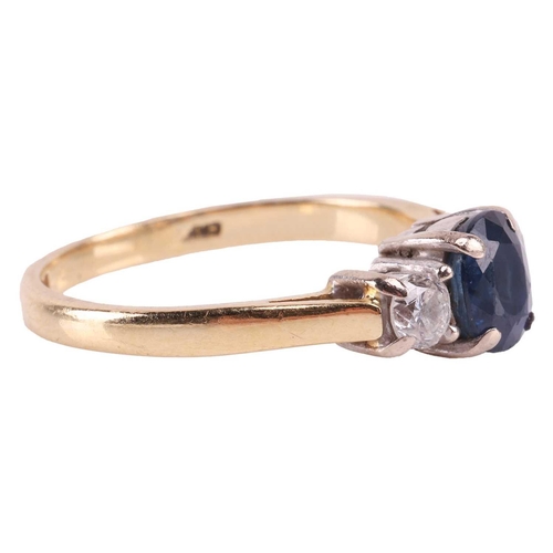 31 - A sapphire and diamond three-stone ring, centred with a claw-set oval-cut sapphire of deep blue colo... 