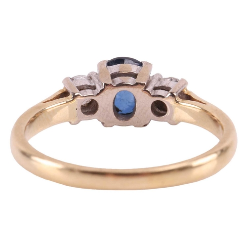 31 - A sapphire and diamond three-stone ring, centred with a claw-set oval-cut sapphire of deep blue colo... 