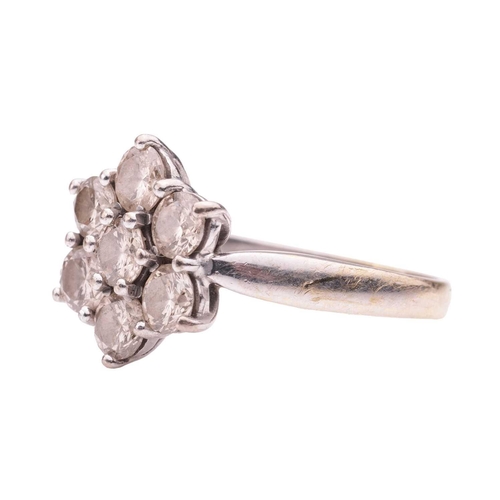 38 - A diamond-set floral cluster ring in 18ct white gold, claw-set with seven round brilliant diamonds, ... 