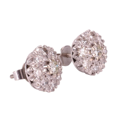 46 - A pair of diamond cluster earrings, each with a raised central round brilliant cut diamond of 0.22ct... 