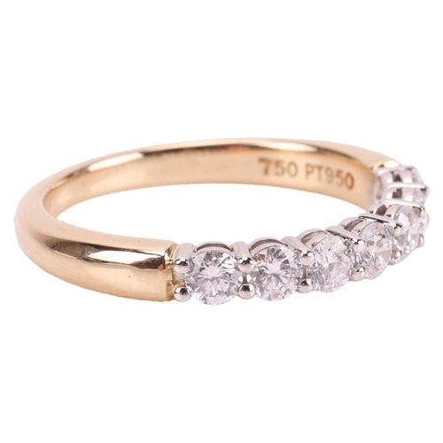 59 - Tiffany & Co - a diamond half-eternity ring, featuring seven round brilliant diamonds with an estima... 