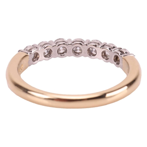 59 - Tiffany & Co - a diamond half-eternity ring, featuring seven round brilliant diamonds with an estima... 