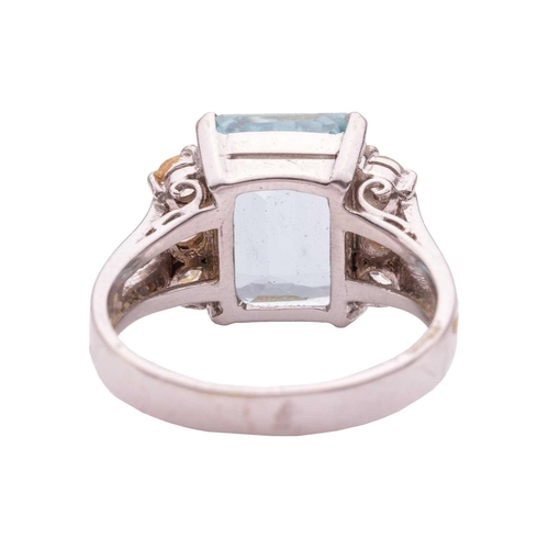 67 - An aquamarine and diamond dress ring, featuring a rectangular step-cut aquamarine with canted corner... 