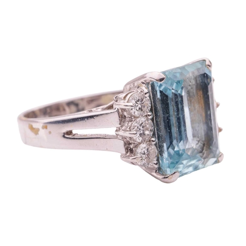 67 - An aquamarine and diamond dress ring, featuring a rectangular step-cut aquamarine with canted corner... 