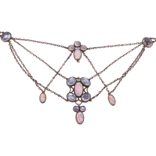 7 - An Art Nouveau moonstone and opal swag necklace, with circular and oval cabochon stones in conformin... 