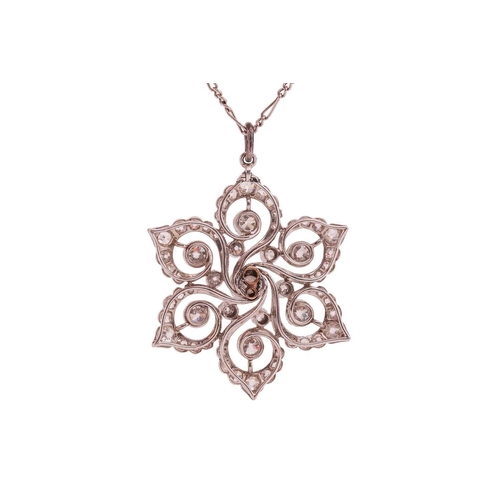 83 - A Belle Epoque diamond cluster pendant on chain, set in an openwork scrolling foliate cluster with t... 