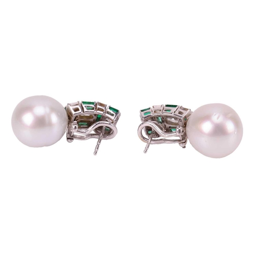 86 - A pair of pearl, emerald and diamond earrings, each features a large egg-shaped white cultured pearl... 