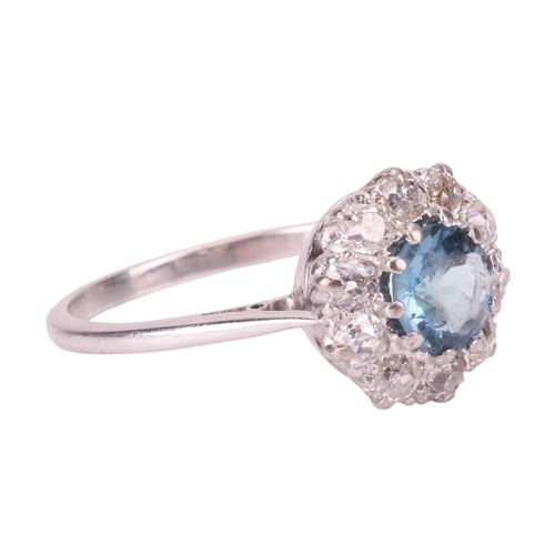 88 - An aquamarine and diamond cluster ring, centred with a circular-cut aquamarine in deep blue colour, ... 