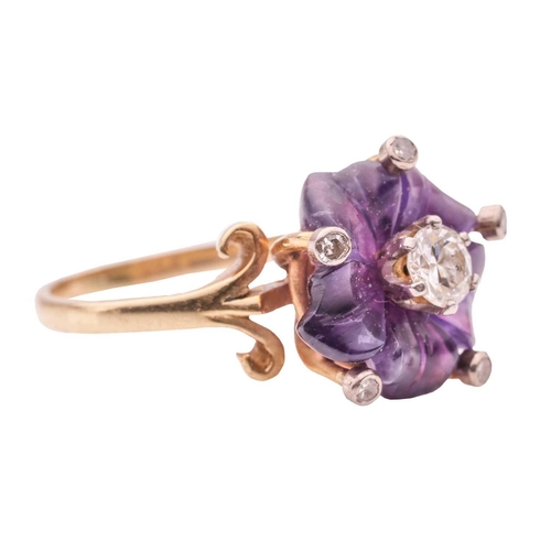 96 - A carved amethyst and diamond dress ring, with a carved amethyst in the form of a flowerhead, set wi... 