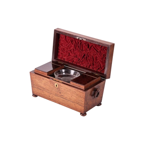 109 - A William IV figured rosewood sarcophagus two-section tea caddy, with a central blending bowl, suppo... 