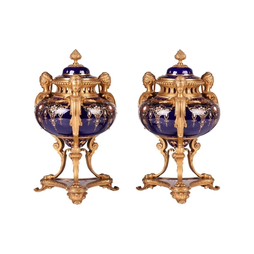 122 - A pair of Sevres style, ormolu mounted French Blu De Roi porcelain potpourri urns, the second half o... 