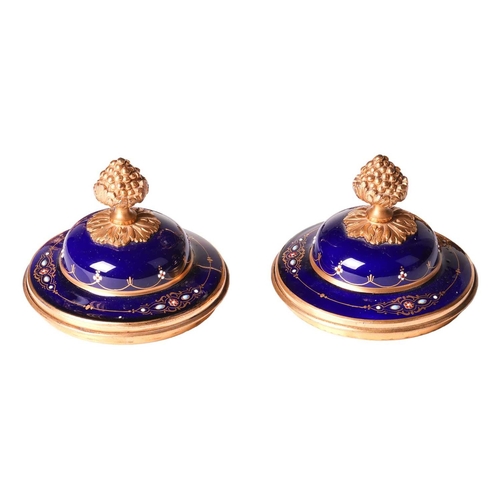 122 - A pair of Sevres style, ormolu mounted French Blu De Roi porcelain potpourri urns, the second half o... 