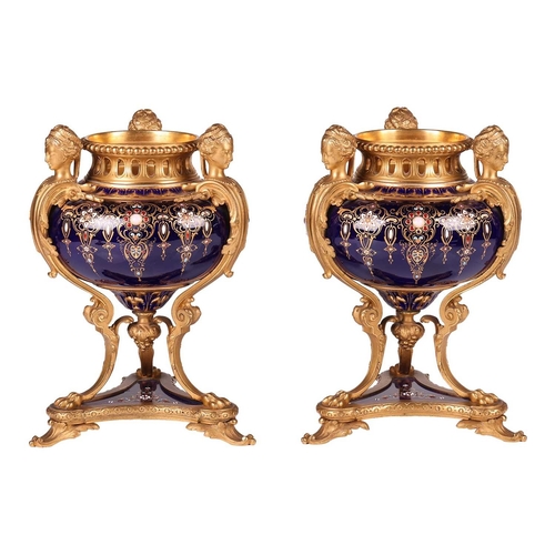 122 - A pair of Sevres style, ormolu mounted French Blu De Roi porcelain potpourri urns, the second half o... 