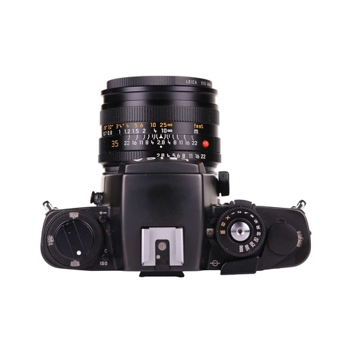 145 - A Leica R4 camera, black, 1983, serial number 1623372, with original instruction booklet, fitted wit... 