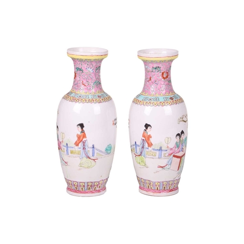 42 - A pair of Chinese late republic Famille Rose porcelain baluster vases, painted with figures in forma... 