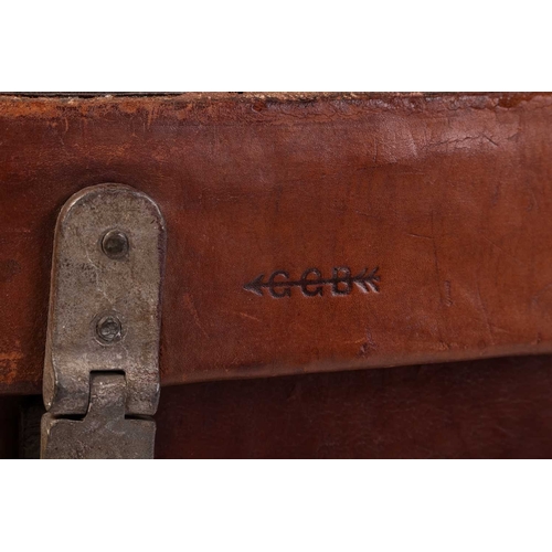 67 - An early 20th-century military, two-handled rectangular leather-clad magazine chest with a fitted in... 