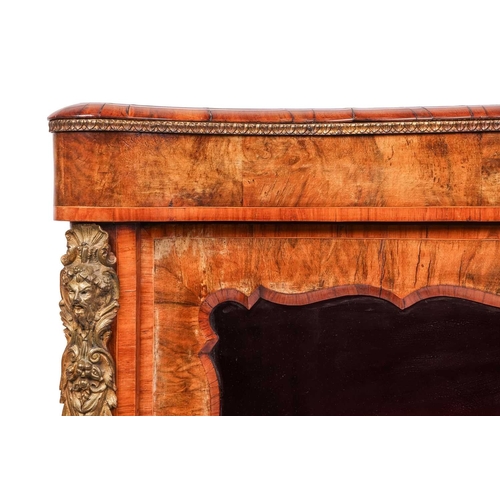 70 - A Victorian figured walnut serpentine chiffonier, fitted a pair of shaped and glazed doors, with gil... 