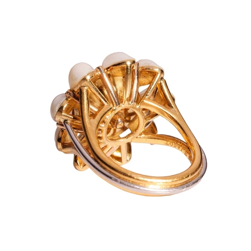 101 - A star sapphire and pearl dress ring in 18ct gold, centred with a collet-set round star sapphire of ... 