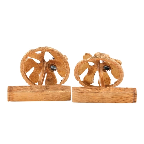 102 - A pair of Modernist textured cufflinks, of organic form within a circular frame, highlighted with ci... 