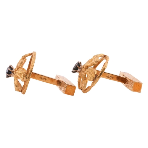 102 - A pair of Modernist textured cufflinks, of organic form within a circular frame, highlighted with ci... 