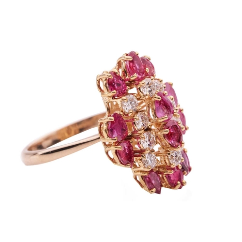 112 - A ruby and diamond cluster ring in 14ct yellow gold, the tiered ring head set with pear-cut rubies a... 