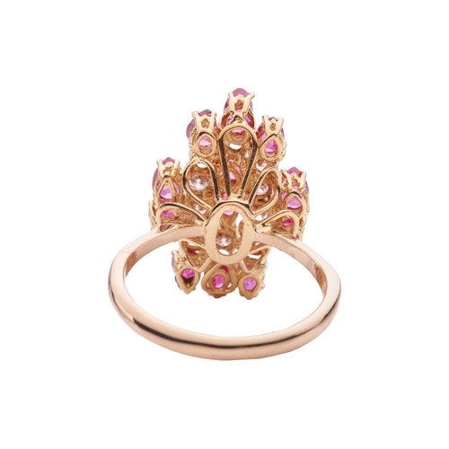 112 - A ruby and diamond cluster ring in 14ct yellow gold, the tiered ring head set with pear-cut rubies a... 