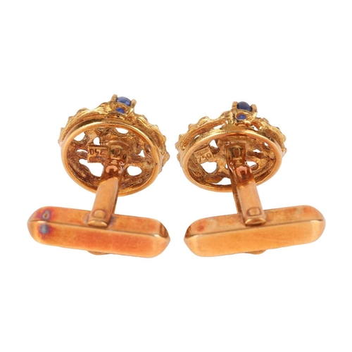 117 - A pair of cufflinks, of organic openwork design, each claw-set with a cabochon blue sapphire, the cu... 