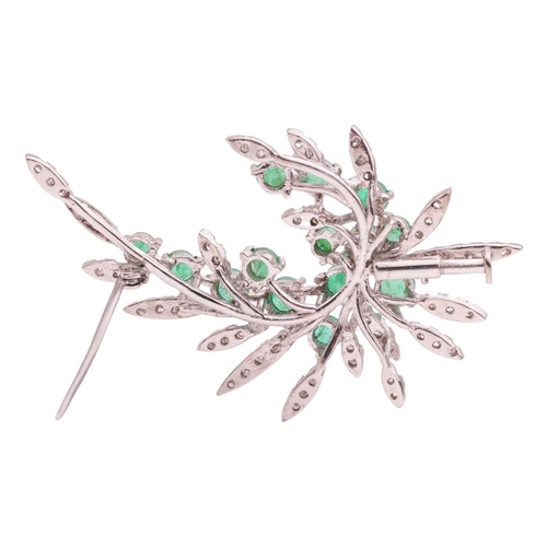 119 - An emerald and diamond spray brooch, a sweep of foliage encrusted with single-cut diamonds, scattere... 