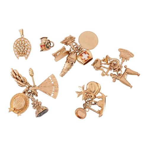 15 - A collection of charms and pendants, including a 9ct gold enamelled ‘toby jug’ charm, an articulated... 