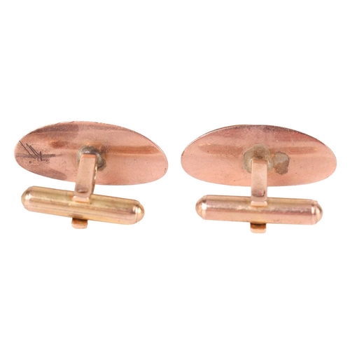 3 - A pair of jadeite-set cufflinks, the textured concave oval panels, each centred with a pear-shaped j... 