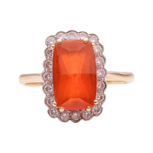 4 - A fire opal and diamond halo ring in 18ct gold, featuring an elongated cushion-shaped fire opal of 1... 