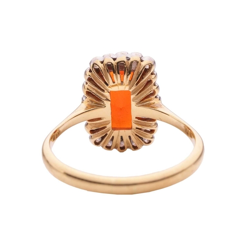 4 - A fire opal and diamond halo ring in 18ct gold, featuring an elongated cushion-shaped fire opal of 1... 