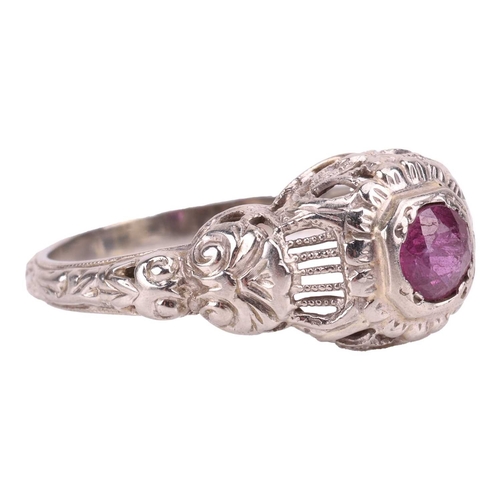 62 - A ruby-set ring, centred with a round-cut ruby of approximately 4.4cm x 4.4cm x 2.4cm, to a detailed... 