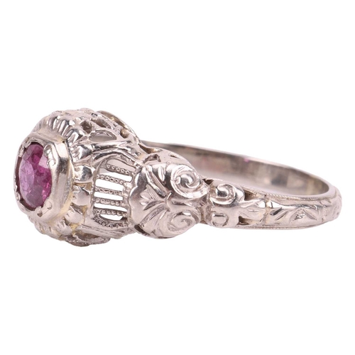 62 - A ruby-set ring, centred with a round-cut ruby of approximately 4.4cm x 4.4cm x 2.4cm, to a detailed... 