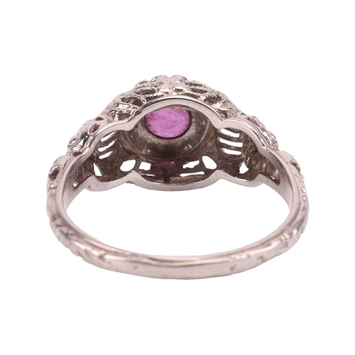 62 - A ruby-set ring, centred with a round-cut ruby of approximately 4.4cm x 4.4cm x 2.4cm, to a detailed... 
