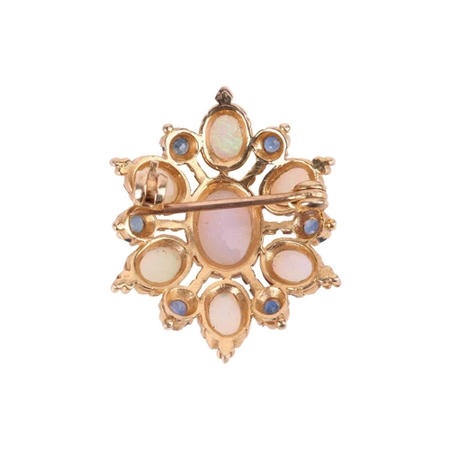 66 - An opal and sapphire cluster brooch in 9ct yellow gold, of floral form, constructed with seven oval-... 