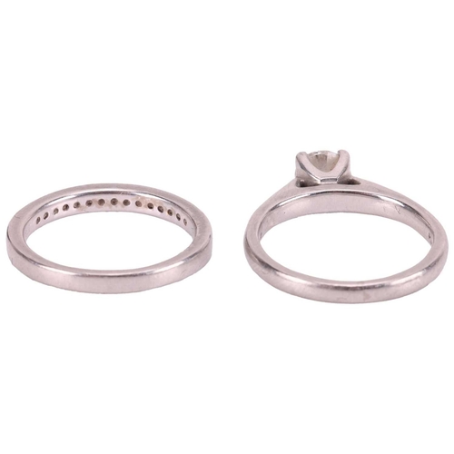 67 - A set of platinum and diamond rings; the solitaire featuring a single round brilliant-cut diamond of... 